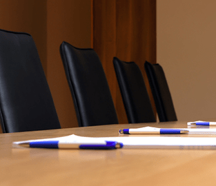 empty board room with paper and pens
