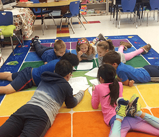 kids laying on floor in a circle