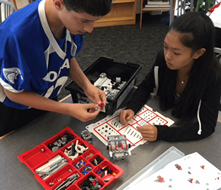 students building with legos