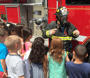students with a firefighter