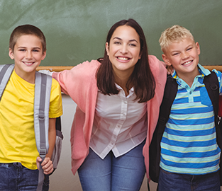 Teacher and students by a chalkboard