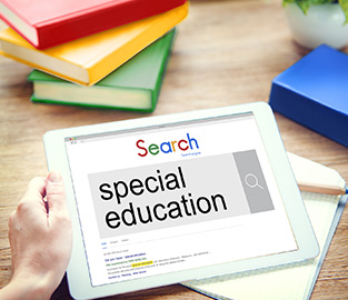 school books and a tablet showing a Google search for special education
